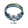 Shark Bracelet Style Pack: 4 blue, black and beige bracelets with a silver-tone shark charm, flat lay on white