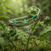 Frog Bracelet Style Pack draped over curled fern fronds in a forest
