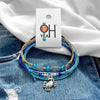 Crab Bracelet Style Pack on its O Yeah four-piece hang tag, laid on denim and a white tee.