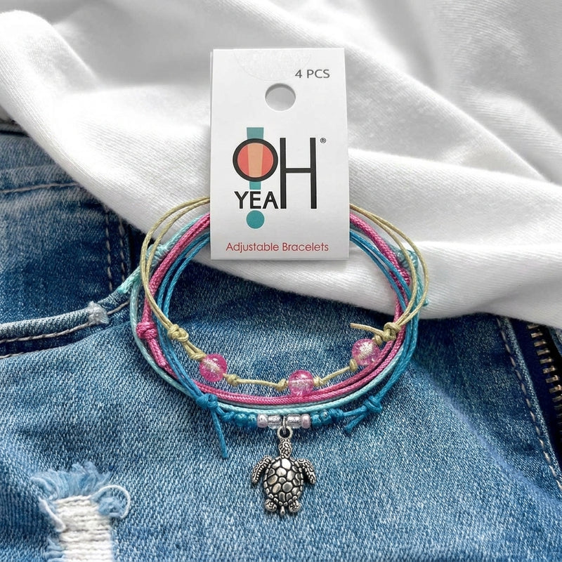 Sea Turtle Bracelet Style Pack Pink on its O Yeah four-piece hang tag, laid on denim and a white tee.