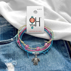 Sea Turtle Bracelet Style Pack Pink on its O Yeah four-piece hang tag, laid on denim and a white tee.