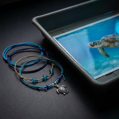 Your Sea Turtle Bracelet Style Pack brings four adjustable bracelets together in ocean-inspired blue and beige