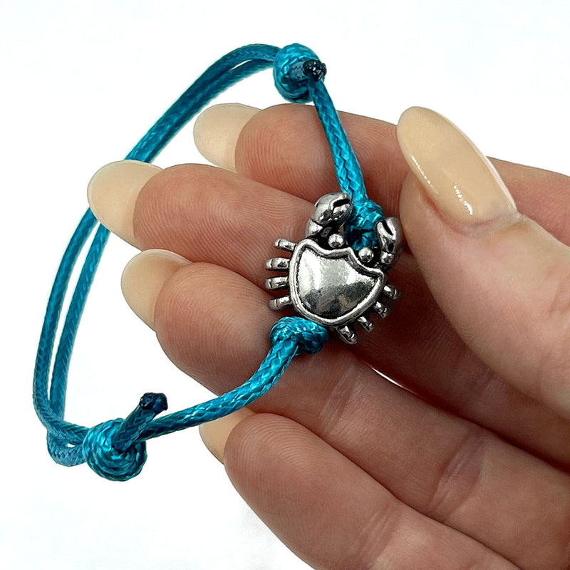 O Yeah Gifts Crab Bracelet – Coastal-inspired bracelet with a silver crab charm and blue cord, perfect for adding beach vibes to any outfit.