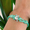 O Yeah Gifts Frog Charm Bracelet – Wrist shot featuring a green cord bracelet with a silver frog charm, perfect for adding a playful, nature-inspired touch to any outfit.