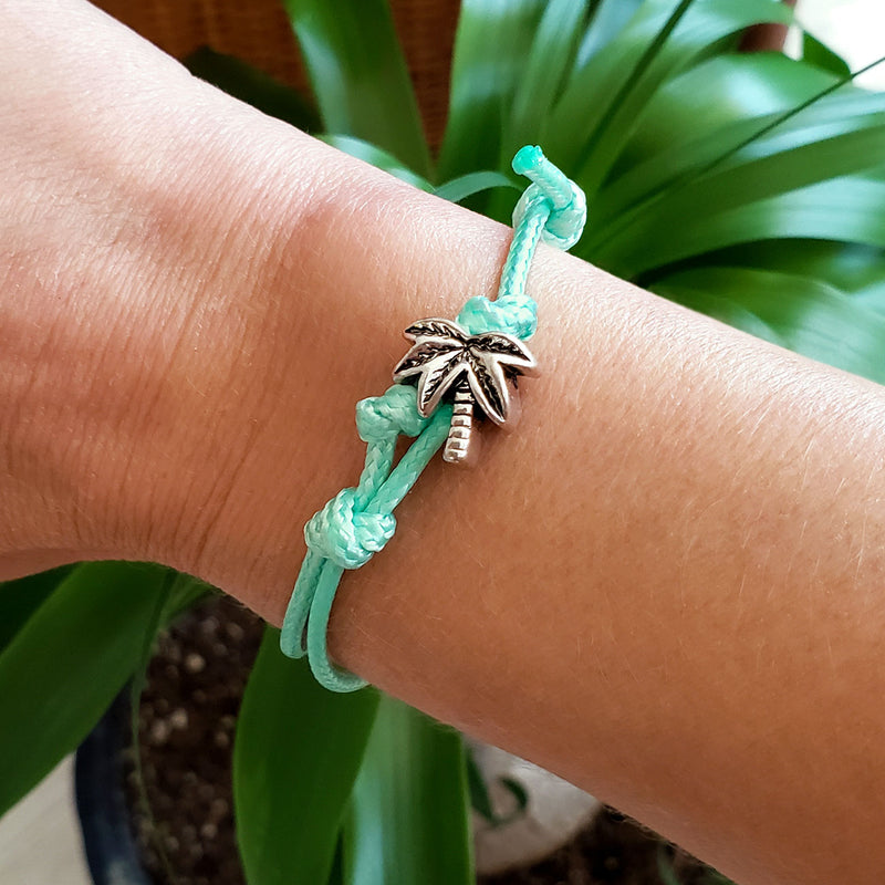 O Yeah Gifts Palm Tree Bracelet – Wrist shot showcasing the mint cord and silver palm tree charm, ideal for beach lovers and summer adventures.