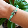 O Yeah Gifts Palm Tree Bracelet – Wrist shot showcasing the mint cord and silver palm tree charm, ideal for beach lovers and summer adventures.