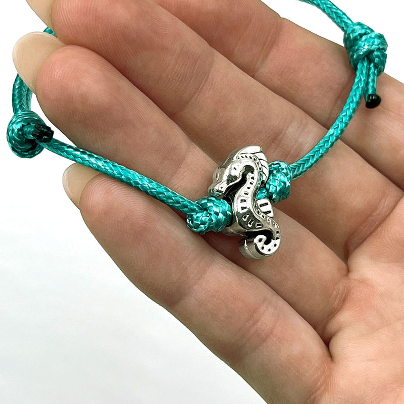 O Yeah Gifts Seahorse Bracelet – Close-up of a turquoise cord bracelet with a silver seahorse charm, perfect for ocean-inspired style.