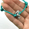 O Yeah Gifts Seahorse Bracelet – Close-up of a turquoise cord bracelet with a silver seahorse charm, perfect for ocean-inspired style.