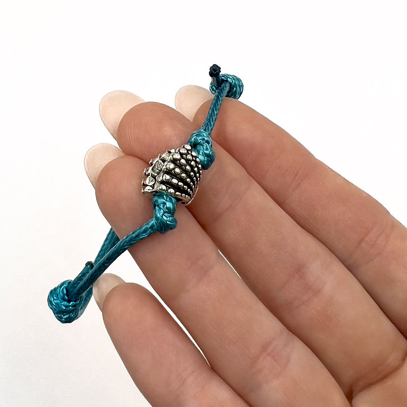 Blue cord shell bracelet featuring a silver shell charm, perfect for beachwear from O Yeah Gifts.