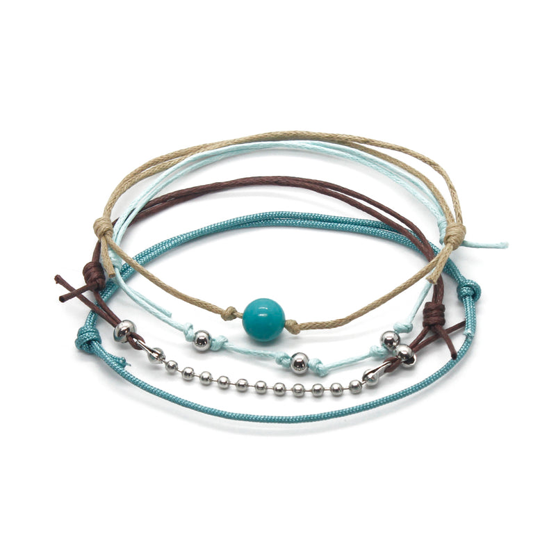 Turquoise gemstone bracelet pack featuring silver wave charms, perfect for ocean-inspired beaded jewelry.