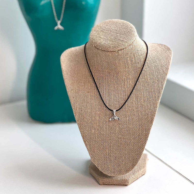 Whale Tail Necklace styled with layered accessories for a trendy ocean-inspired look.