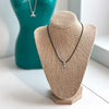 Whale Tail Necklace styled with layered accessories for a trendy ocean-inspired look.